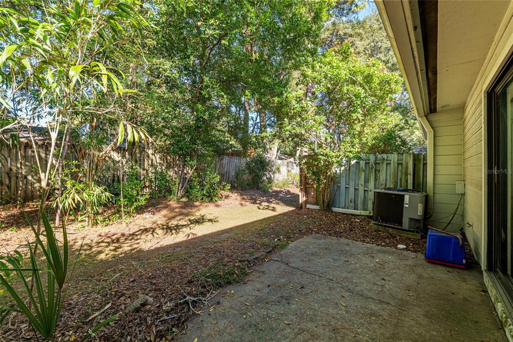 3057 Northwest 28th Circle Gainesville, FL 32605 - Photo 47 of 50 a view of a yard with plants and wooden fence