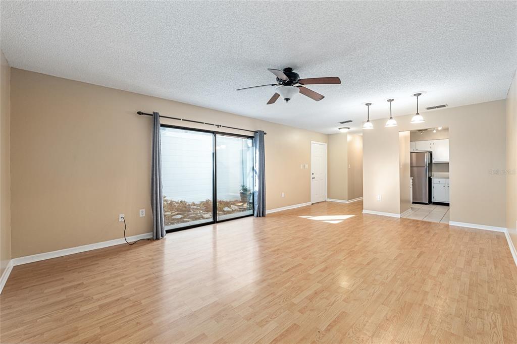 3057 Northwest 28th Circle Gainesville, FL 32605 - Photo 7 of 50 a view of an empty room with a window and wooden floor