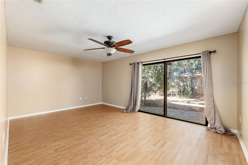 3057 Northwest 28th Circle Gainesville, FL 32605 - Photo 9 of 50 wooden floor in an empty room with a window