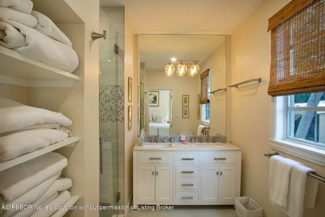 a bathroom with a sink a mirror and a shower