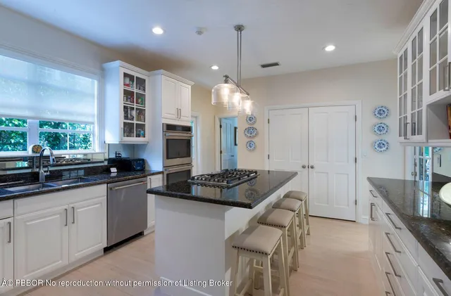 a kitchen with counter top space cabinets and stainless steel appliances