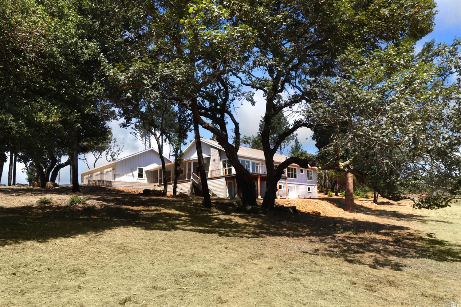 a view of yard covered with snow in front of house
