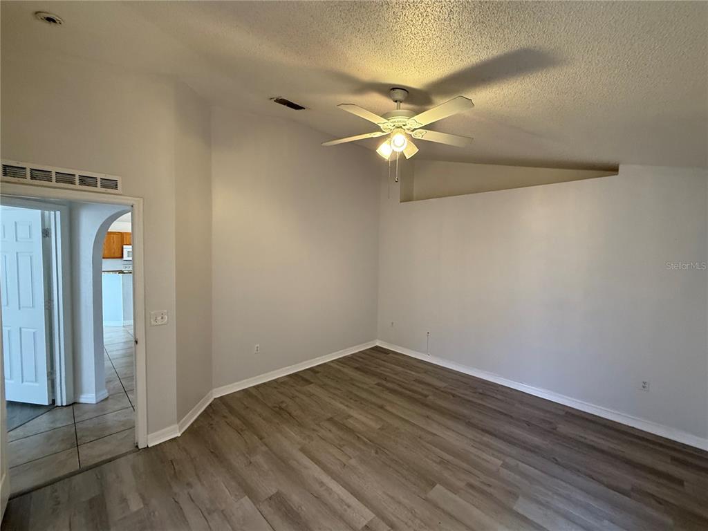 10455 Fly Fishing Street Riverview, FL 33569 - Photo 11 of 25 an empty room with wooden floor fan and windows