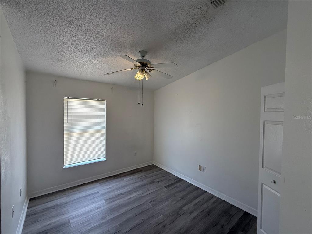 10455 Fly Fishing Street Riverview, FL 33569 - Photo 17 of 25 an empty room with wooden floor fan and windows