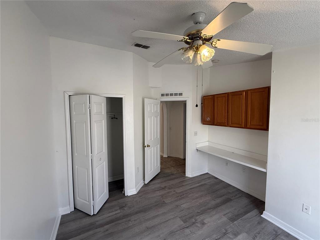 10455 Fly Fishing Street Riverview, FL 33569 - Photo 18 of 25 a view of a livingroom with wooden floor and a ceiling fan