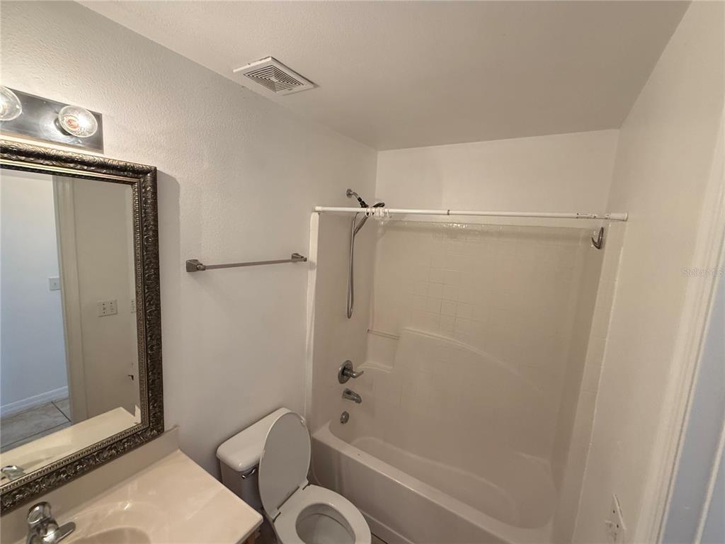 10455 Fly Fishing Street Riverview, FL 33569 - Photo 20 of 25 a bathroom with a granite countertop bathtub shower and toilet