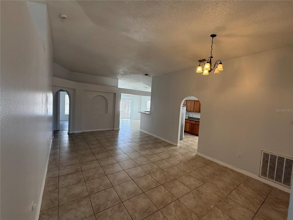10455 Fly Fishing Street Riverview, FL 33569 - Photo 3 of 25 a view of a hallway with a chandelier