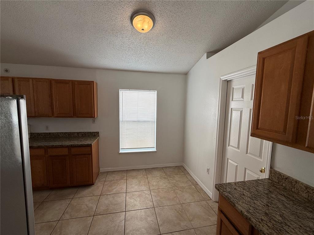 10455 Fly Fishing Street Riverview, FL 33569 - Photo 8 of 25 a kitchen with a refrigerator stove and cabinets