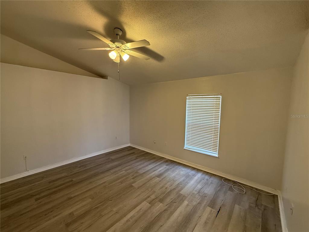 10455 Fly Fishing Street Riverview, FL 33569 - Photo 10 of 25 a view of an empty room with wooden floor and a window