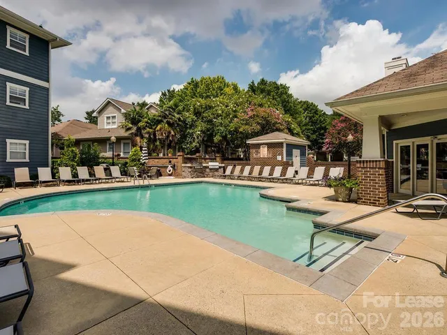 a swimming pool with outdoor seating and yard