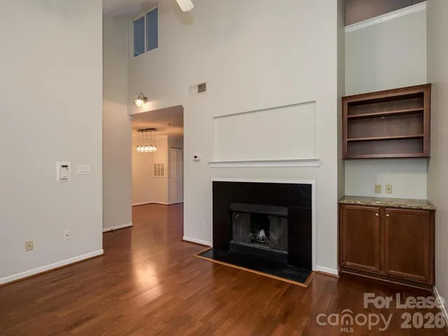 a view of a livingroom with a fireplace and a wooden floor