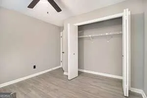an empty room with wooden floor and closet