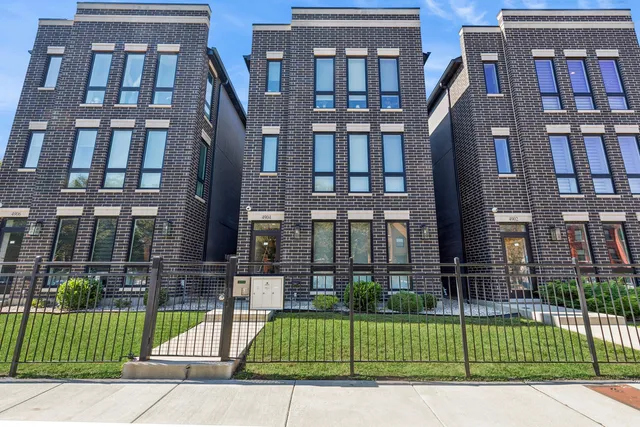 a view of a brick building next to a yard