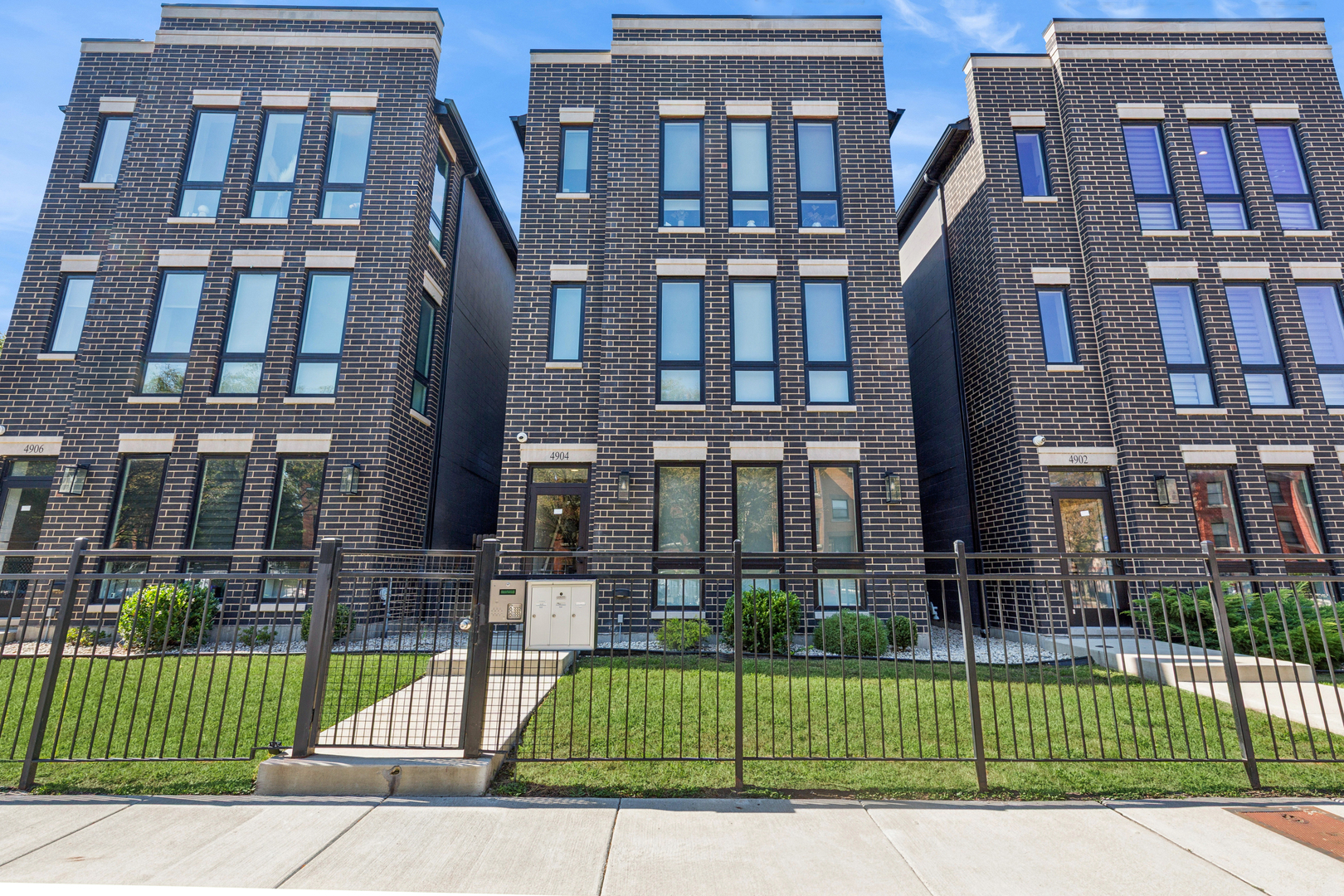 a view of a brick building next to a yard