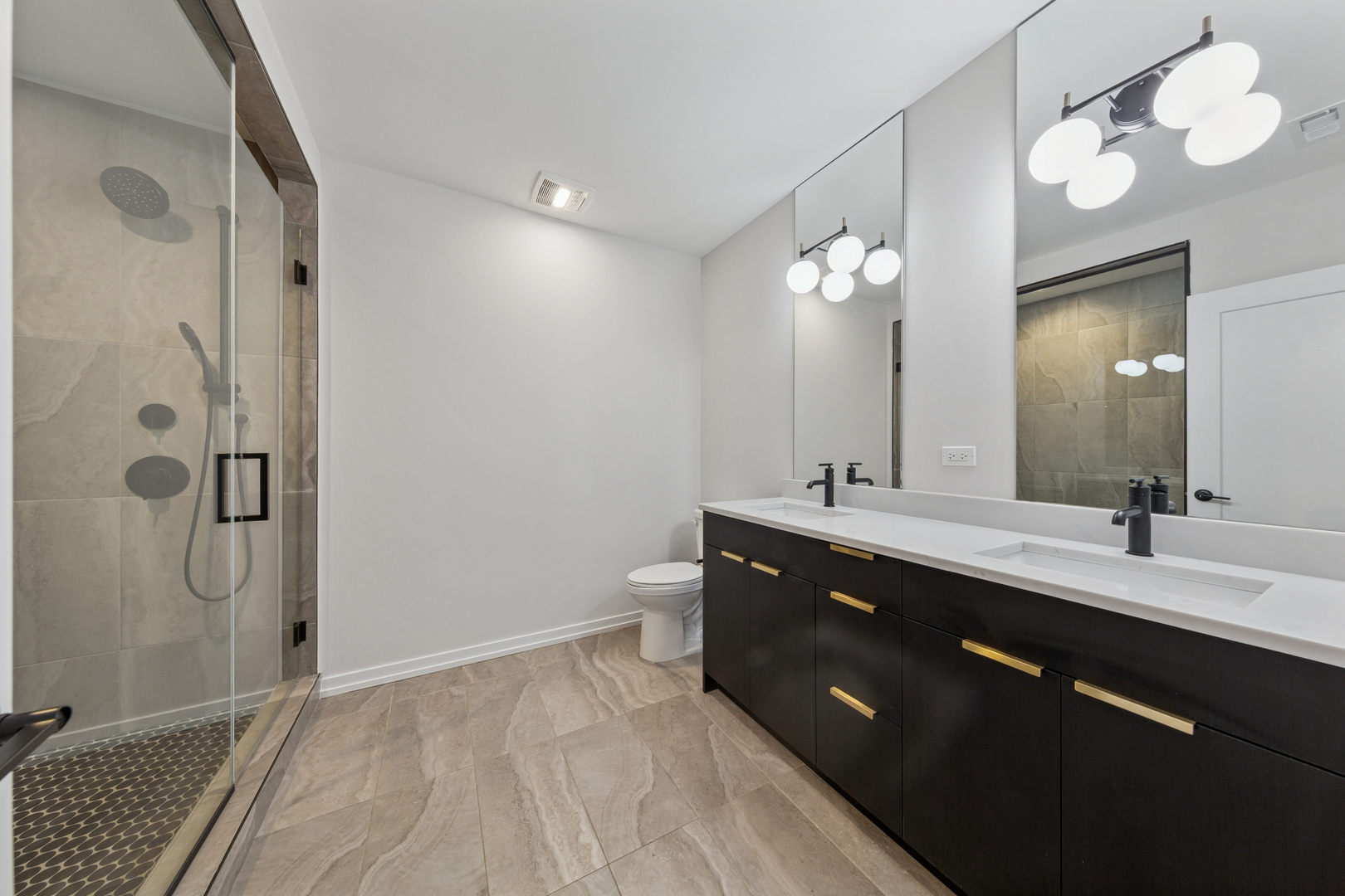 4904 South St Lawrence Avenue, Unit 2 Chicago, IL 60615 - Photo 16 of 19 a spacious bathroom with a double vanity sink mirror and shower