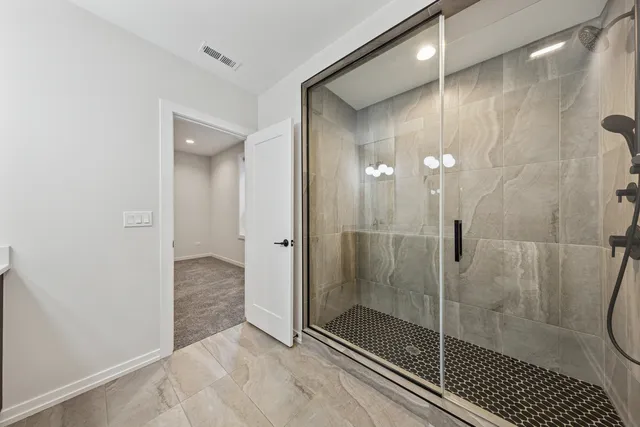 a bathroom with a glass shower door