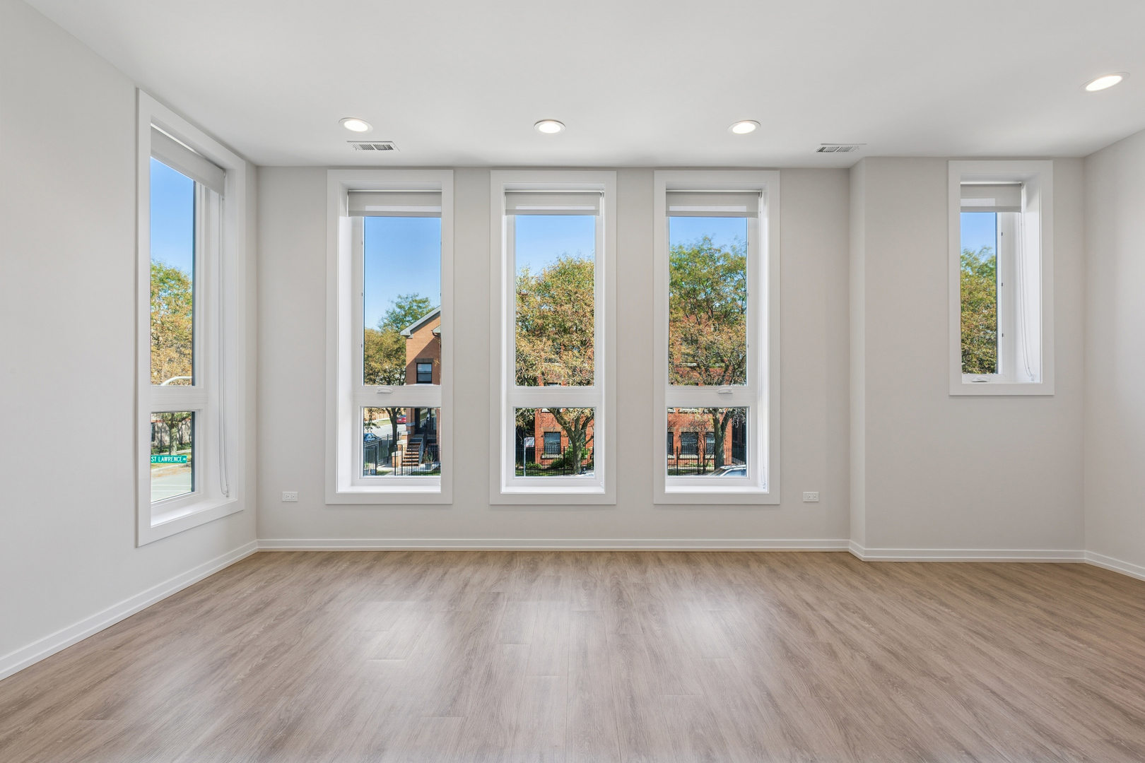 4904 South St Lawrence Avenue, Unit 2 Chicago, IL 60615 - Photo 2 of 19 an empty room with wooden floor and windows