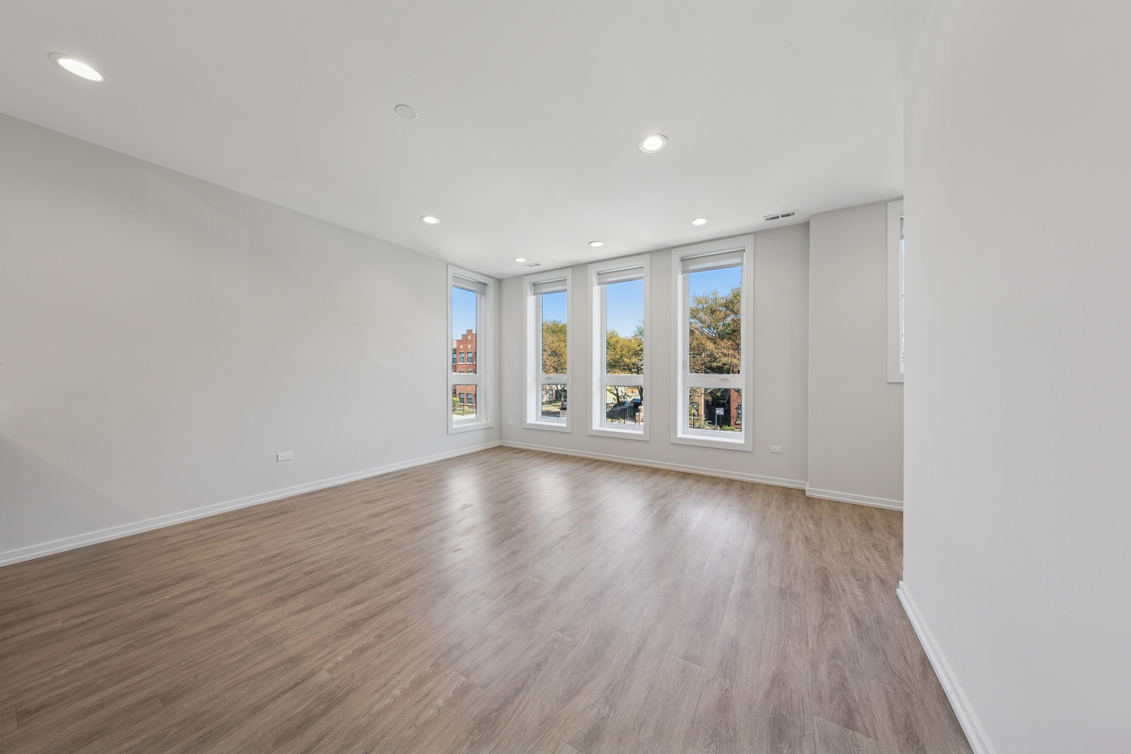 4904 South St Lawrence Avenue, Unit 2 Chicago, IL 60615 - Photo 3 of 19 a view of an empty room with a window and wooden floor