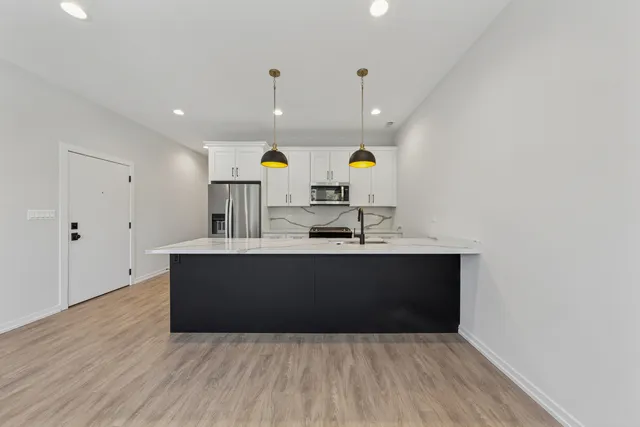 a kitchen with a sink and a cabinet with wooden floor