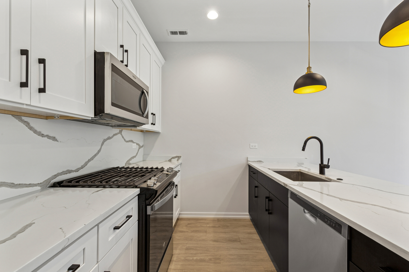 4904 South St Lawrence Avenue, Unit 2 Chicago, IL 60615 - Photo 8 of 19 a kitchen with a sink a stove and a microwave