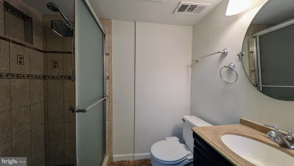 a white toilet sitting next to a bathroom sink