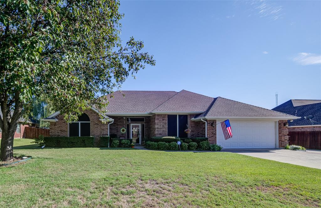 1709 Meadowbrook Court Decatur, TX 76234 - Photo 1 of 1 a front view of a house with a garden