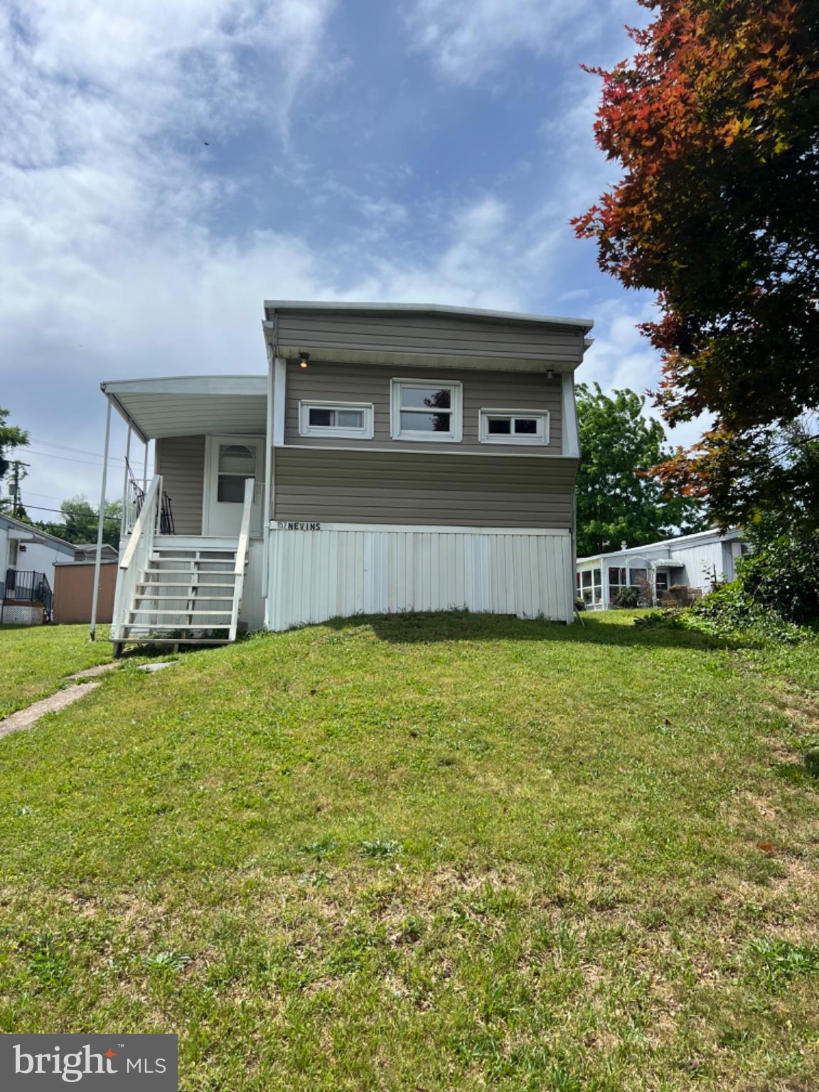1302 Gibson Road, Unit 152 Bensalem, PA 19020 - Photo 16 of 18 a front view of a house with a garden