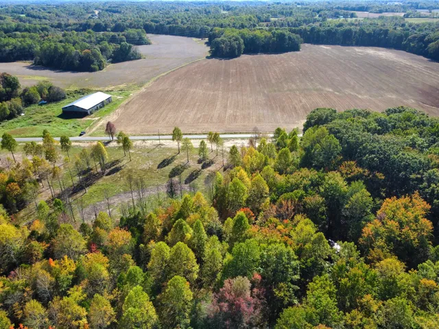 an aerial view of a house with a yard and outdoor seating