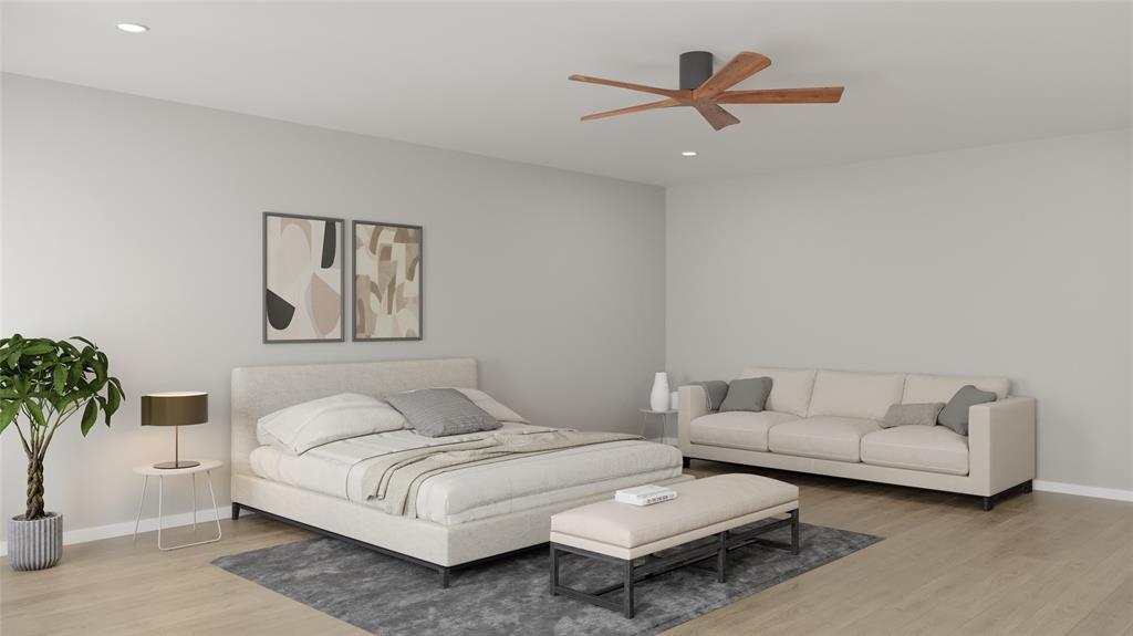 a bedroom with a bed couches and a potted plant