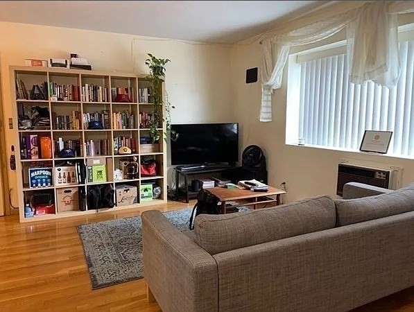a living room with furniture and a book shelf
