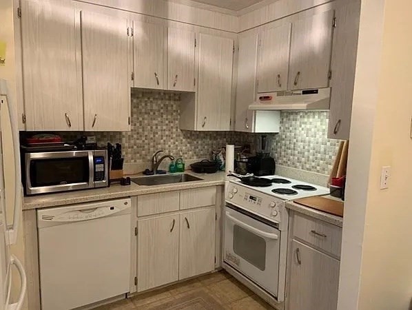 10 Scottfield Road, Unit 14 Boston, MA 02134 - Photo 3 of 7 a kitchen with cabinets stainless steel appliances and sink