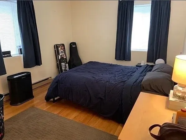 a bedroom with a bed and a window