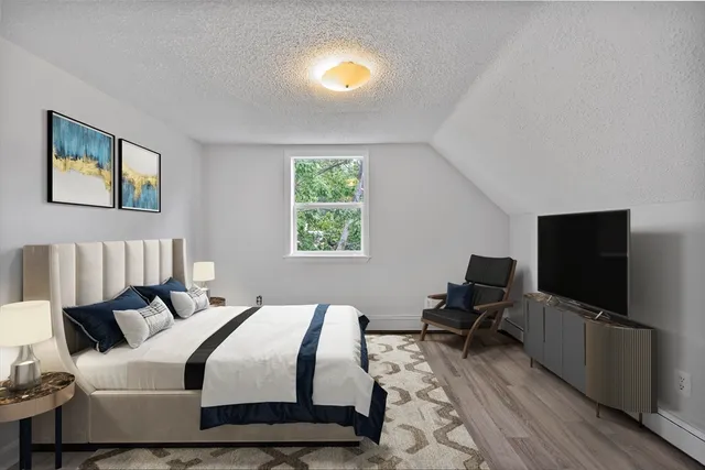 a bedroom with a bed and a flat screen tv