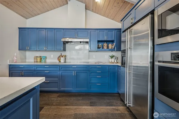a kitchen with refrigerator and cabinets