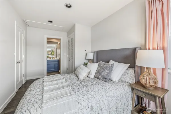 a bedroom with a bed and a lamp