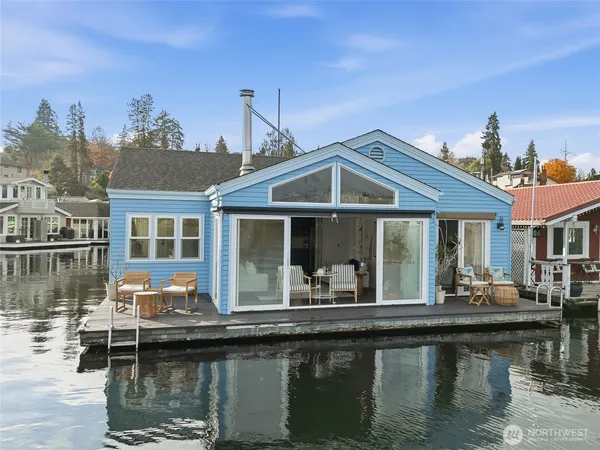 a front view of a house with swimming pool having outdoor seating