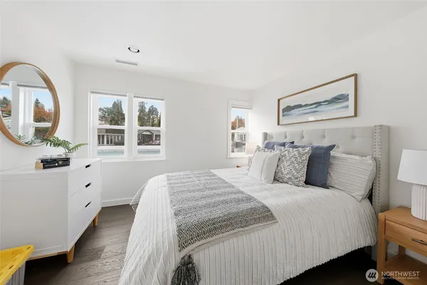 a bedroom with a large bed and a dresser