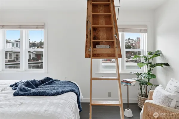 a bedroom with a bed window and table