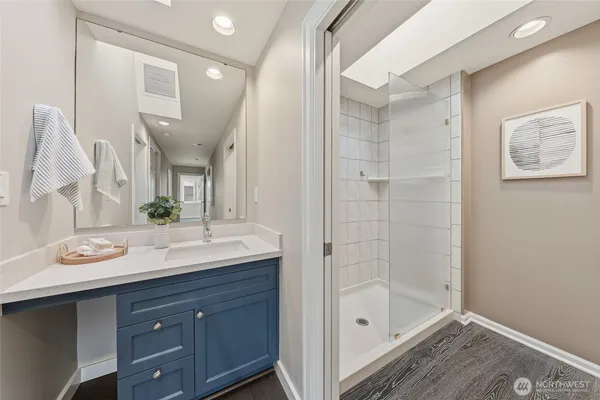 a bathroom with a sink double vanity granite tub and shower