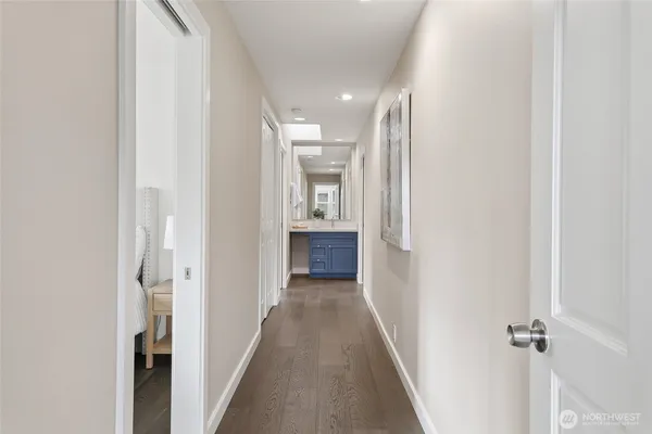 a view of a hallway with wooden floor and closet
