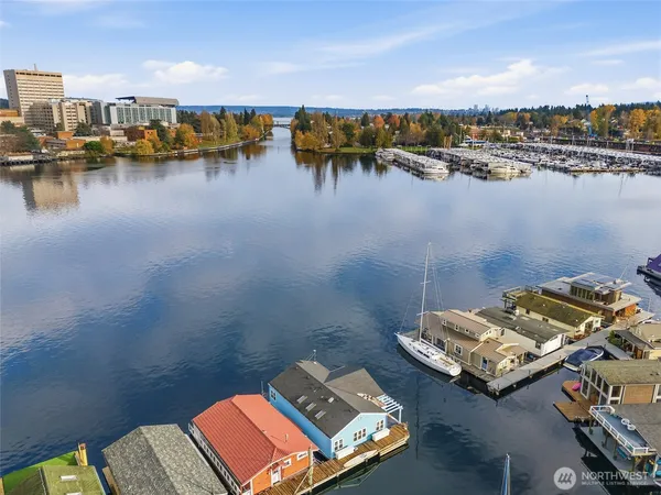 a view of a ocean with boats and trees in the background