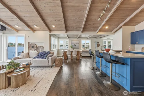 a living room with lots of furniture and hard wood flooring