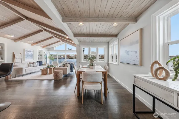 a dining room with furniture wooden floor and a rug