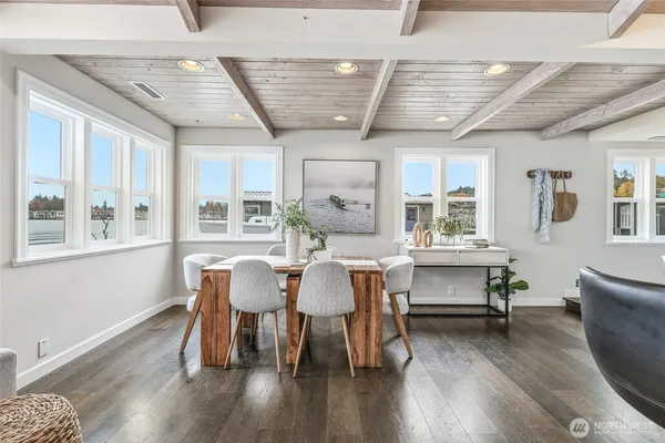 a dining room with wooden floor and furniture