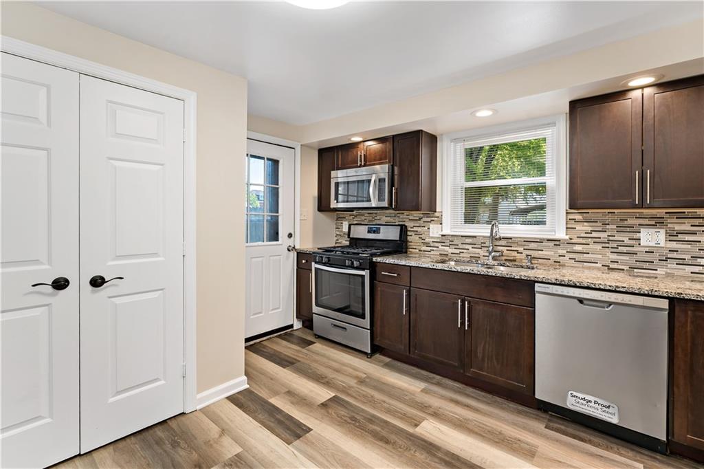 357 Gregg Street Carnegie, PA 15106 - Photo 8 of 34 a kitchen with granite countertop a stove sink and microwave