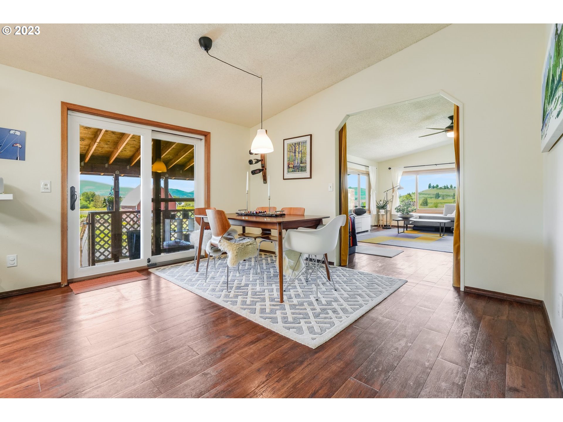 2766 Eastside Road Hood River, OR 97031 - Photo 7 of 30 a dining room with wooden floor a glass table and chairs