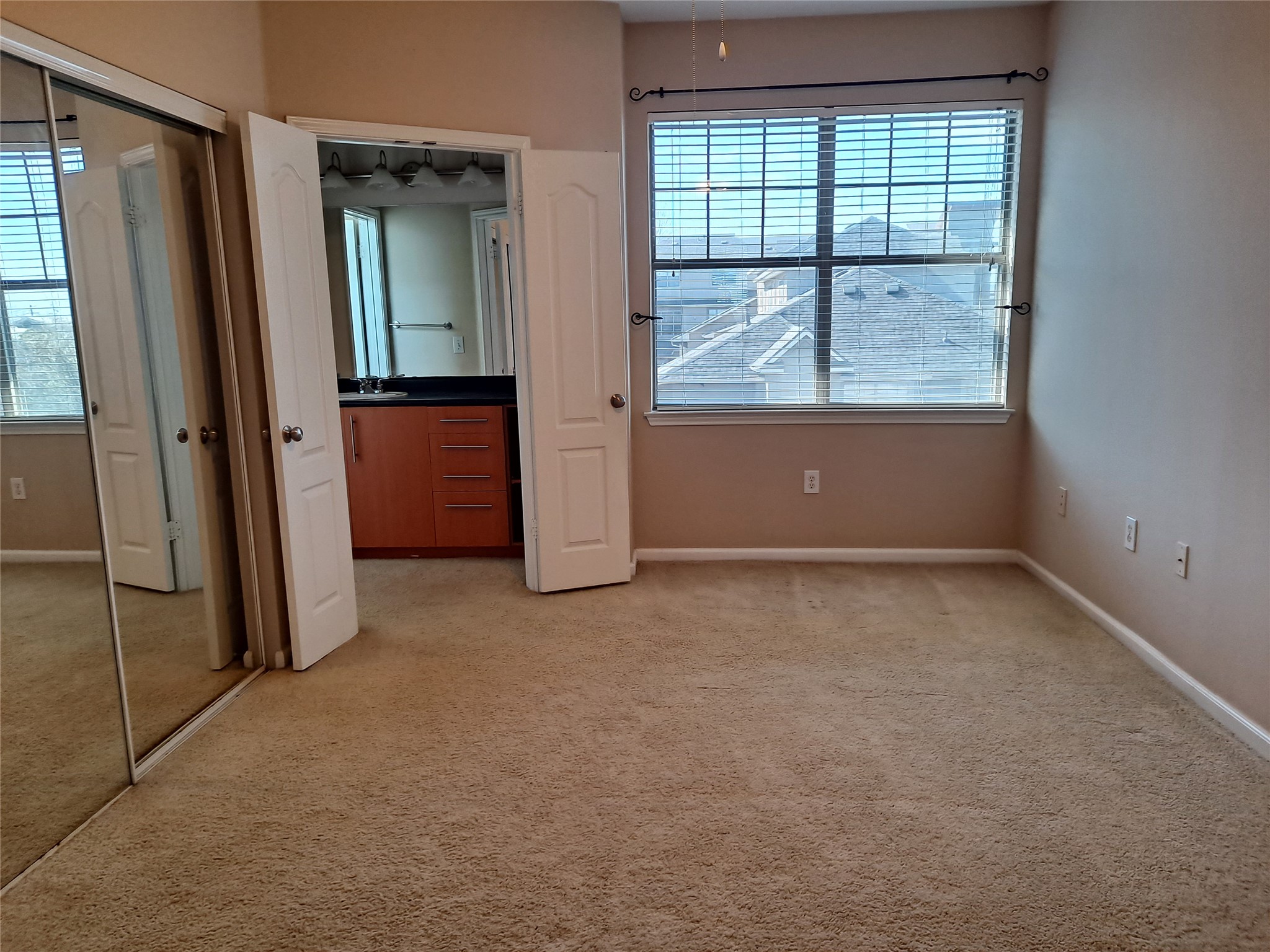 11203 Ranch Road 2222, Unit 2404 Austin, TX 78730 - Photo 12 of 28 Unfurnished bedroom featuring light colored carpet, a closet, and ensuite bathroom