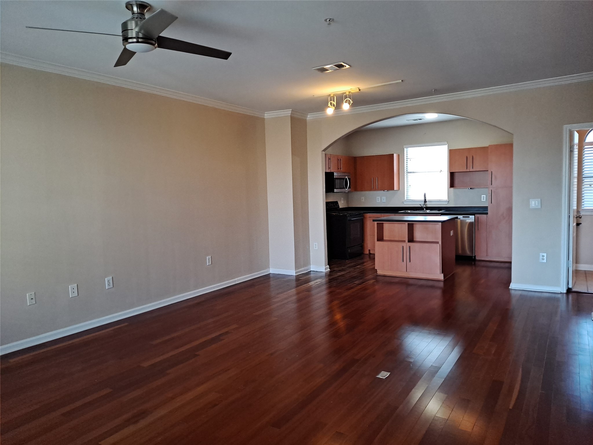 11203 Ranch Road 2222, Unit 2404 Austin, TX 78730 - Photo 27 of 28 Kitchen featuring dark countertops, open floor plan, crown molding, stainless steel appliances, and ceiling fan