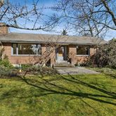 a front view of a house with a yard table and chairs