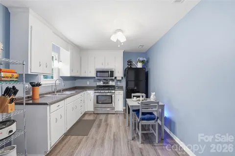 a kitchen with a white cabinets and white appliances
